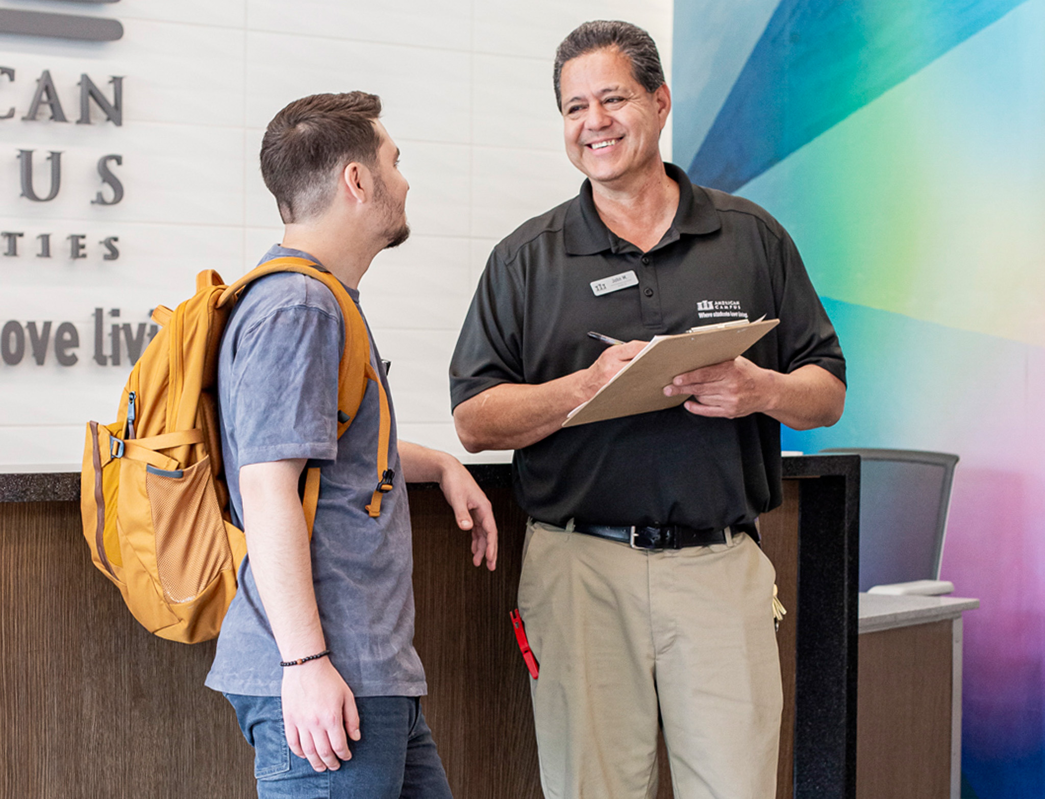 Facilities Team Member and Student interact at Front Desk